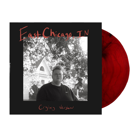 Vinyl record album with a black and white cover photo and red vinyl disc.