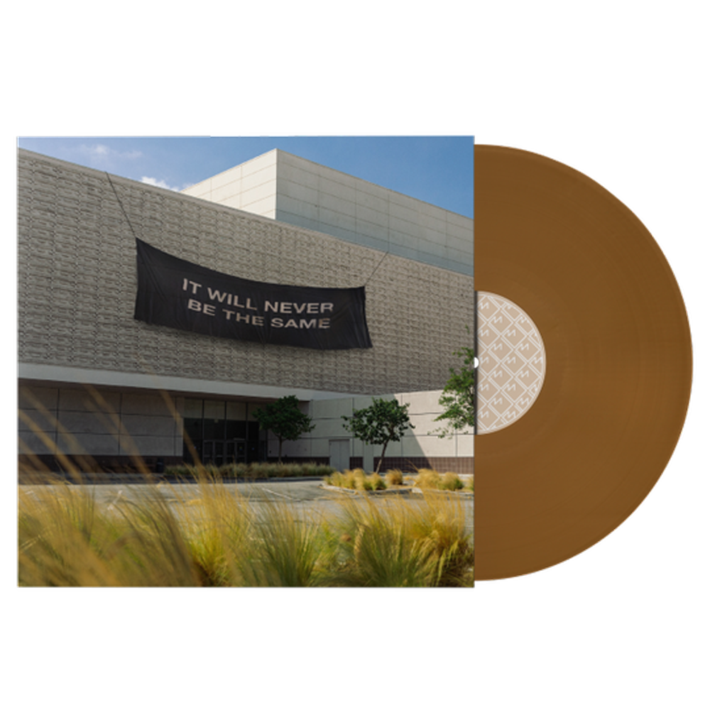 Brown vinyl record album with a cover image of a modern building facade.