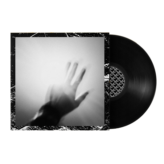 Vinyl record album with a cover showing a blurry hand silhouette against a light background.