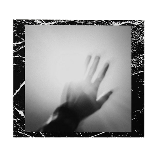 Shadowy silhouette of an outstretched hand against a blurry background.