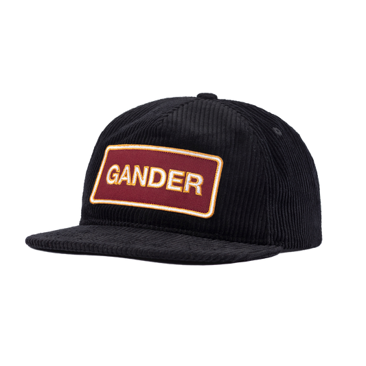 Black corduroy baseball cap with a rectangular ’GANDER’ patch on the front.